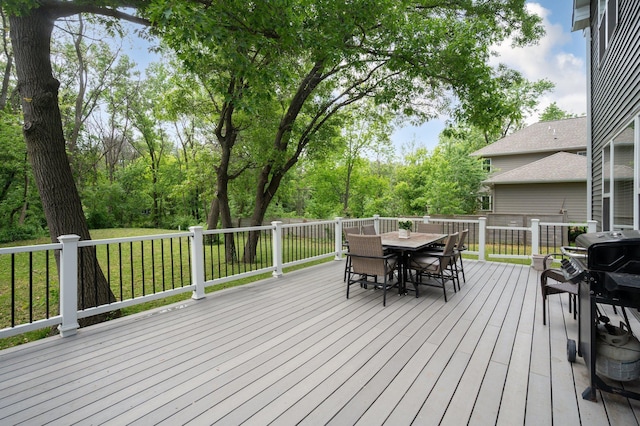 12601 Ridgemount Ave W, Minnetonka, MN 55305 - deck with outdoor dining space, a yard, and a grill