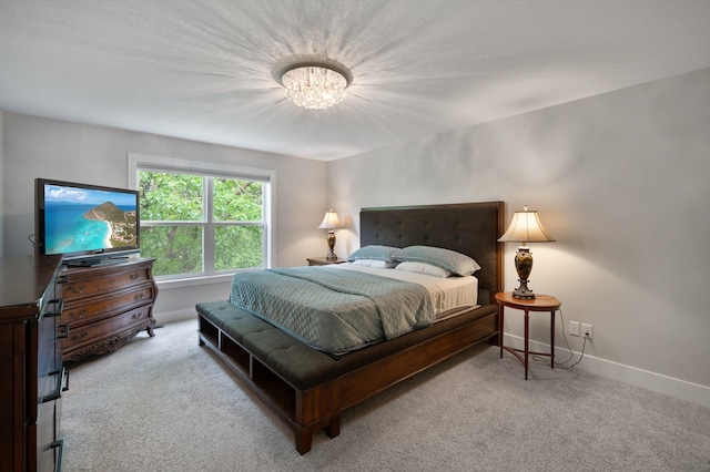 12601 Ridgemount Ave W, Minnetonka, MN 55305 - bedroom with a chandelier, carpet floors, and baseboards