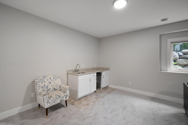 12601 Ridgemount Ave W, Minnetonka, MN 55305 - sitting room featuring bar with sink, light carpet, and baseboards