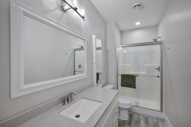 12601 Ridgemount Ave W, Minnetonka, MN 55305 - bathroom featuring toilet, a stall shower, vanity, and wood finished floors