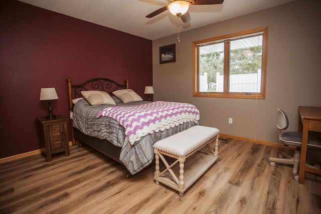 2501 Woodridge Ln, Brainerd, MN 56401 - bedroom featuring light wood-type flooring, baseboards, ceiling fan, and an accent wall