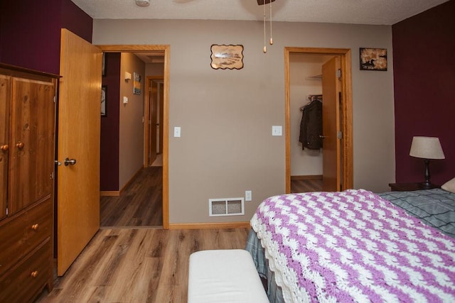 2501 Woodridge Ln, Brainerd, MN 56401 - bedroom with light wood finished floors, a spacious closet, a closet, and baseboards