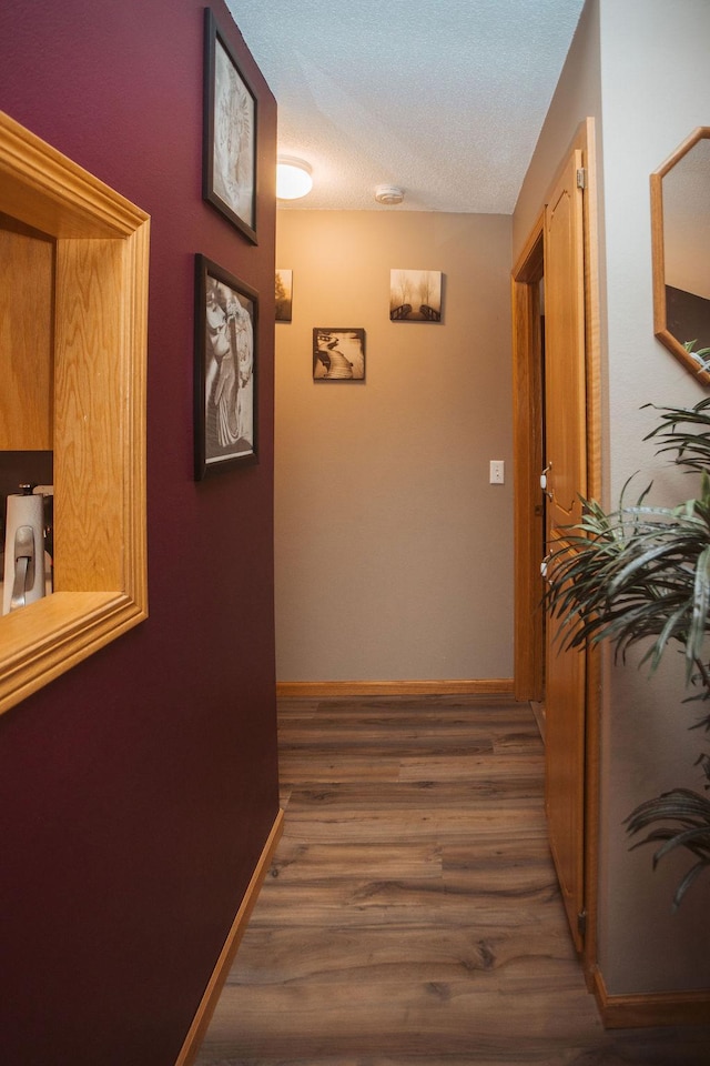 2501 Woodridge Ln, Brainerd, MN 56401 - hallway with wood finished floors, a textured ceiling, and baseboards
