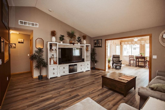 2501 Woodridge Ln, Brainerd, MN 56401 - living room with dark wood-style flooring, baseboards, and high vaulted ceiling