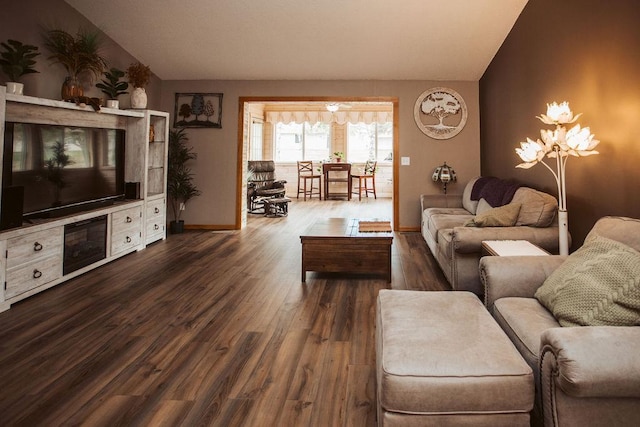 2501 Woodridge Ln, Brainerd, MN 56401 - living area with lofted ceiling, dark wood-style flooring, and baseboards
