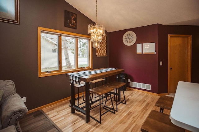 2501 Woodridge Ln, Brainerd, MN 56401 - dining space with light wood-style flooring, baseboards, a chandelier, and lofted ceiling