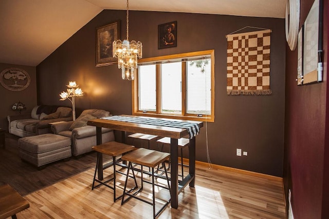 2501 Woodridge Ln, Brainerd, MN 56401 - dining space featuring light wood-style flooring, lofted ceiling, a chandelier, and baseboards
