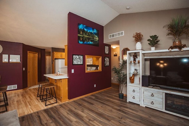 2501 Woodridge Ln, Brainerd, MN 56401 - living area with wood finished floors, high vaulted ceiling, and baseboards