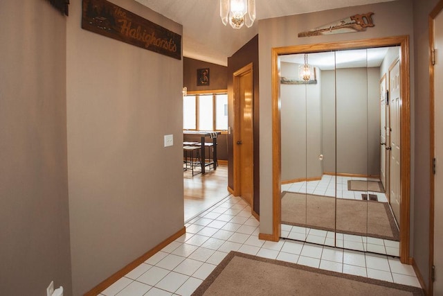 2501 Woodridge Ln, Brainerd, MN 56401 - hallway featuring a chandelier, light tile patterned flooring, and baseboards