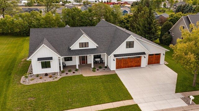 918 Hidden Meadow Ln, Lake City, MN 55041 - modern farmhouse style home featuring board and batten siding, a porch, roof with shingles, and a front yard