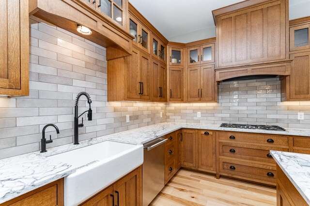 918 Hidden Meadow Ln, Lake City, MN 55041 - kitchen with stainless steel appliances, a sink, brown cabinetry, and tasteful backsplash
