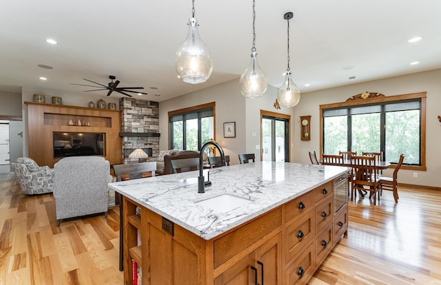 918 Hidden Meadow Ln, Lake City, MN 55041 - kitchen featuring a sink, ceiling fan, light wood finished floors, a fireplace, and recessed lighting