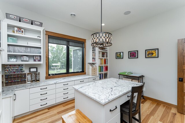 918 Hidden Meadow Ln, Lake City, MN 55041 - kitchen featuring light wood-style floors, white cabinetry, a center island, baseboards, and light stone counters