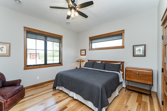 918 Hidden Meadow Ln, Lake City, MN 55041 - bedroom featuring multiple windows, light wood-style floors, baseboards, and ceiling fan