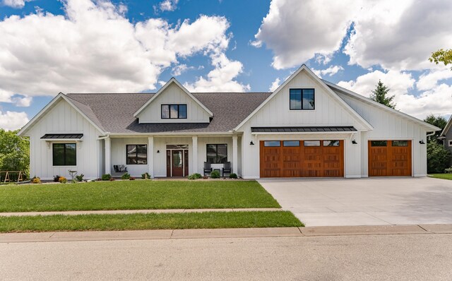 918 Hidden Meadow Ln, Lake City, MN 55041 - modern inspired farmhouse with board and batten siding, a standing seam roof, a front yard, and driveway