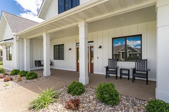 918 Hidden Meadow Ln, Lake City, MN 55041 - view of exterior entry with covered porch, roof with shingles, and board and batten siding