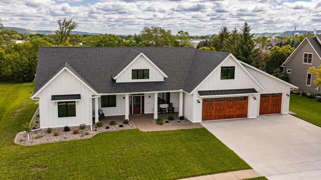 918 Hidden Meadow Ln, Lake City, MN 55041 - modern inspired farmhouse featuring a porch, board and batten siding, a standing seam roof, and a shingled roof