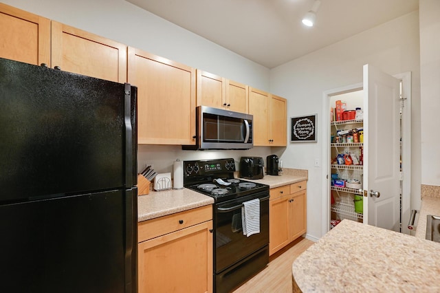 13580 Technology Dr Unit 3222, Eden Prairie, MN 55344 - kitchen with black appliances, light brown cabinetry, light countertops, and light wood finished floors
