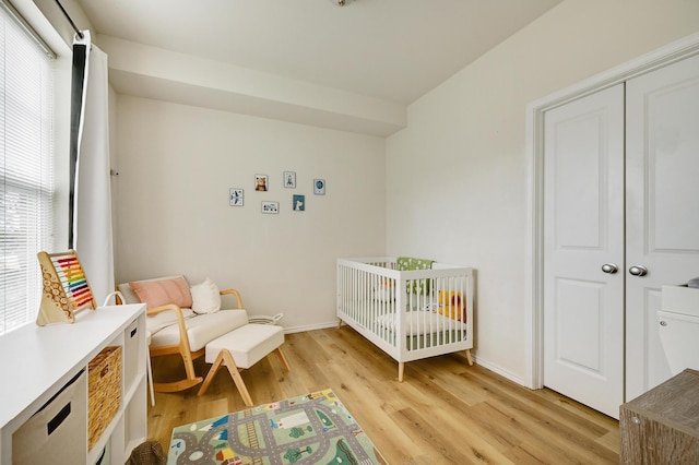 13580 Technology Dr Unit 3222, Eden Prairie, MN 55344 - bedroom featuring light wood-style floors, baseboards, a nursery area, and a closet