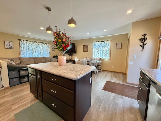 2014 Nelson Dr, Thief River Falls, MN 56701 - kitchen with light wood-style floors, light countertops, dark brown cabinets, hanging light fixtures, and recessed lighting