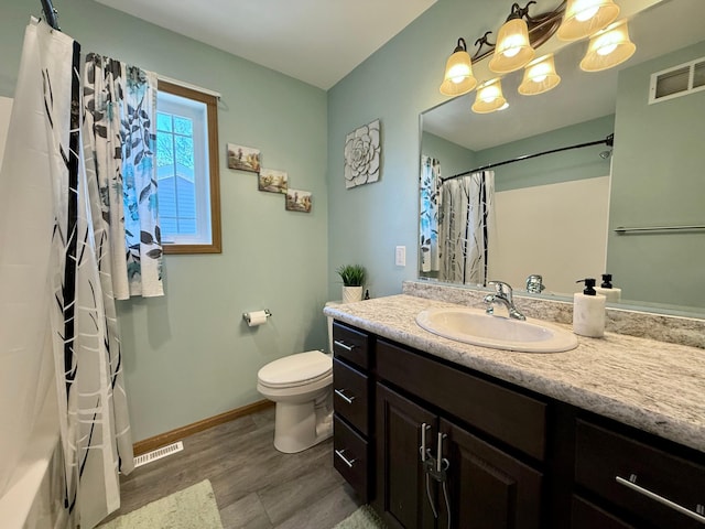 2014 Nelson Dr, Thief River Falls, MN 56701 - full bath with vanity, toilet, baseboards, and wood finished floors