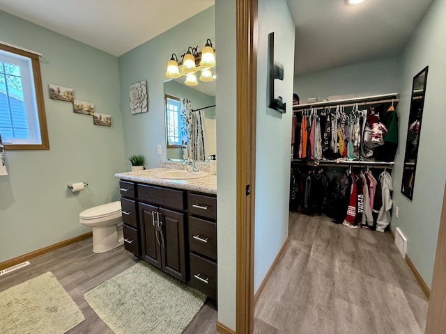 2014 Nelson Dr, Thief River Falls, MN 56701 - full bath with wood finished floors, vanity, toilet, and baseboards