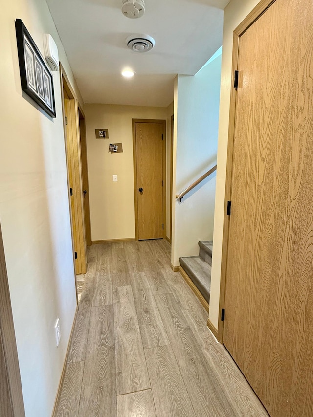 2014 Nelson Dr, Thief River Falls, MN 56701 - corridor featuring light wood-style flooring, baseboards, and stairs
