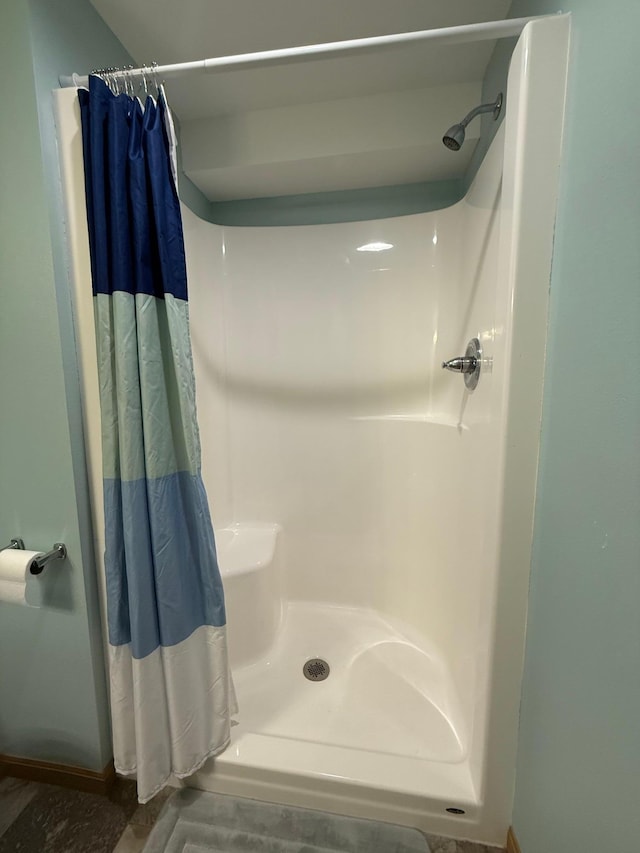 2014 Nelson Dr, Thief River Falls, MN 56701 - bathroom with a shower with curtain and baseboards