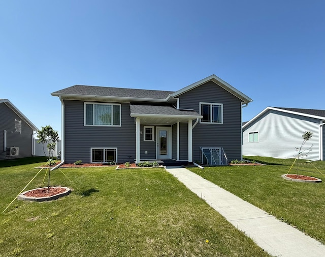2014 Nelson Dr, Thief River Falls, MN 56701 - view of front of home with a front yard, ac unit, and a shingled roof