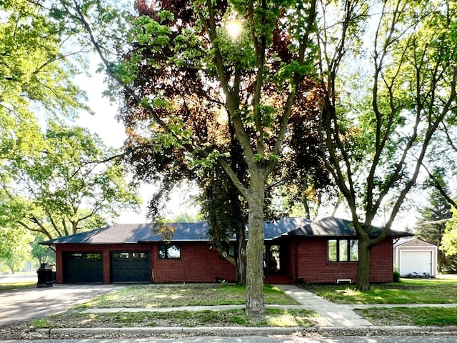 424 Gaulke St, Appleton, MN 56208 - view of side of property with an attached garage, brick siding, and driveway