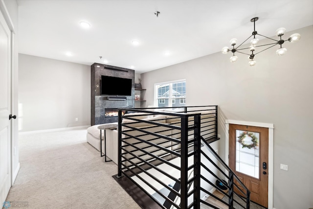 5837 41st St S, Fargo, ND 58104 - staircase with a chandelier, a fireplace, carpet floors, baseboards, and recessed lighting