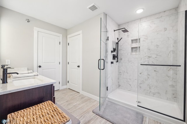 5837 41st St S, Fargo, ND 58104 - full bathroom with a marble finish shower, wood finished floors, baseboards, vanity, and recessed lighting