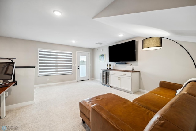 5837 41st St S, Fargo, ND 58104 - living area featuring bar with sink, wine cooler, baseboards, light carpet, and recessed lighting