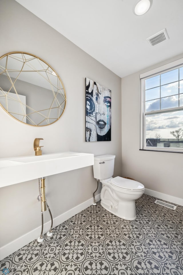 5837 41st St S, Fargo, ND 58104 - bathroom with baseboards and toilet