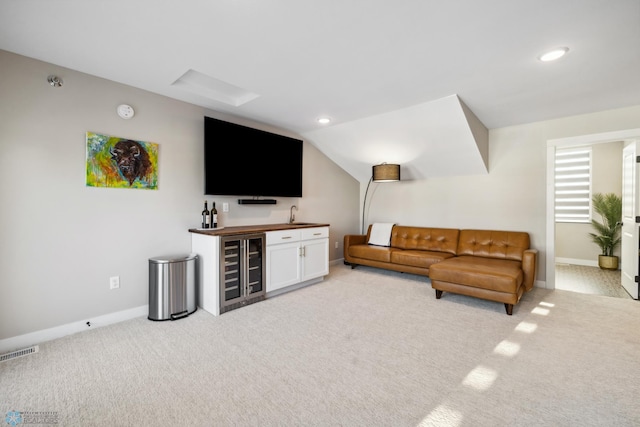 5837 41st St S, Fargo, ND 58104 - living room featuring wine cooler, light carpet, bar, baseboards, and recessed lighting