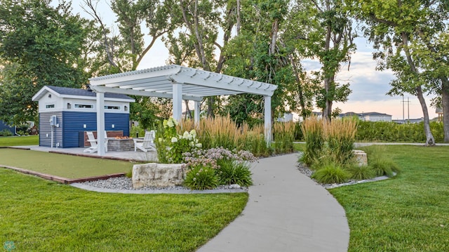 5837 41st St S, Fargo, ND 58104 - view of green lawn featuring a pergola, a fire pit, and an outdoor structure
