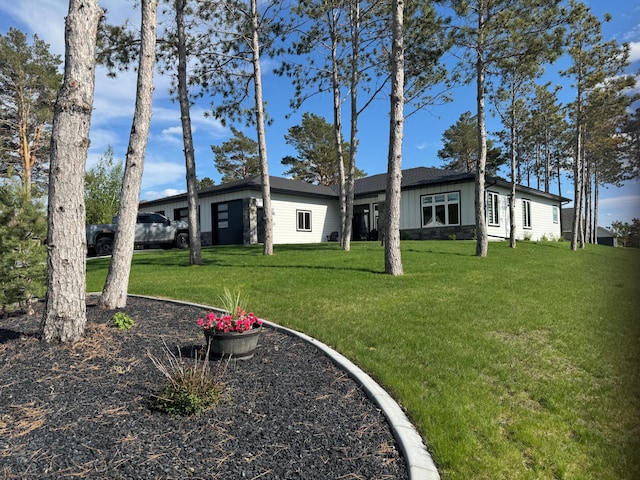 807 Whitetail Ln, Detroit Lakes, MN 56501 - view of front of home with a garage, board and batten siding, and a front lawn