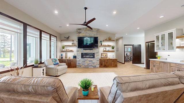807 Whitetail Ln, Detroit Lakes, MN 56501 - living area with ceiling fan, light wood-style floors, a stone fireplace, vaulted ceiling, and recessed lighting