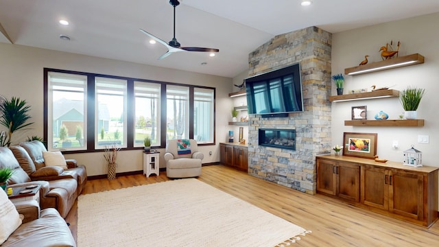 807 Whitetail Ln, Detroit Lakes, MN 56501 - living area featuring light wood-style floors, a ceiling fan, vaulted ceiling, and a fireplace