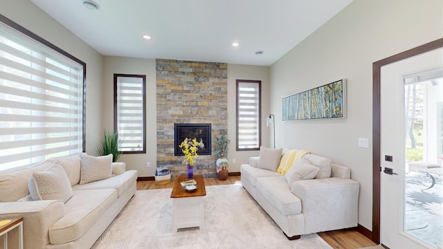 807 Whitetail Ln, Detroit Lakes, MN 56501 - living room featuring light wood-style flooring, a stone fireplace, baseboards, and recessed lighting