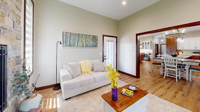 807 Whitetail Ln, Detroit Lakes, MN 56501 - living room with baseboards, light wood-style floors, a stone fireplace, and recessed lighting
