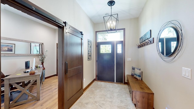 807 Whitetail Ln, Detroit Lakes, MN 56501 - foyer entrance featuring a barn door, a chandelier, baseboards, and light wood-style floors
