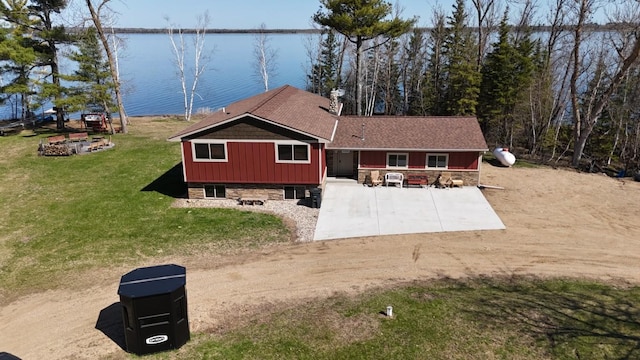 46824 Foss Rd, Osage, MN 56570 - rear view of house with a water view, a lawn, and board and batten siding