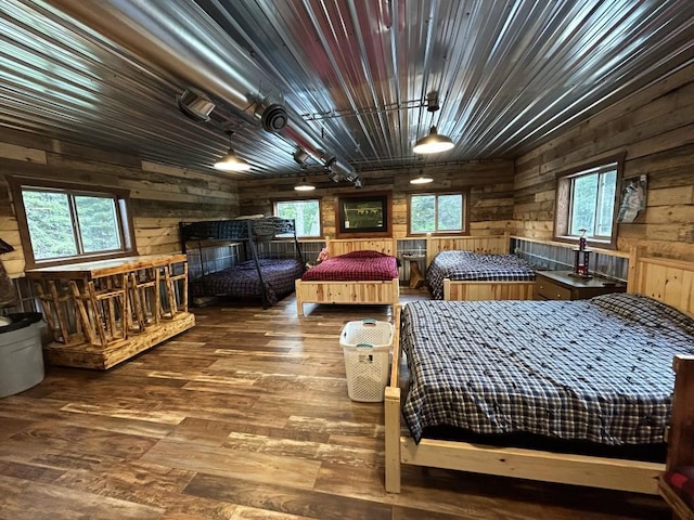 46824 Foss Rd, Osage, MN 56570 - bedroom featuring wood walls, hardwood / wood-style flooring, and multiple windows