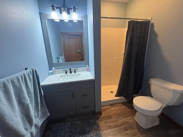 46824 Foss Rd, Osage, MN 56570 - full bathroom with wood finished floors, toilet, vanity, and a shower stall