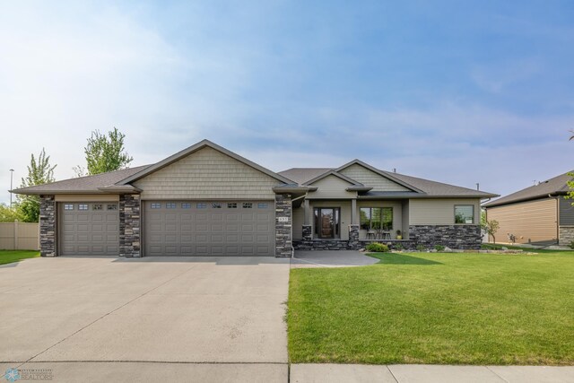 695 20 1/2 Ave E, West Fargo, ND 58078 - craftsman inspired home featuring a front yard, concrete driveway, an attached garage, and stone siding