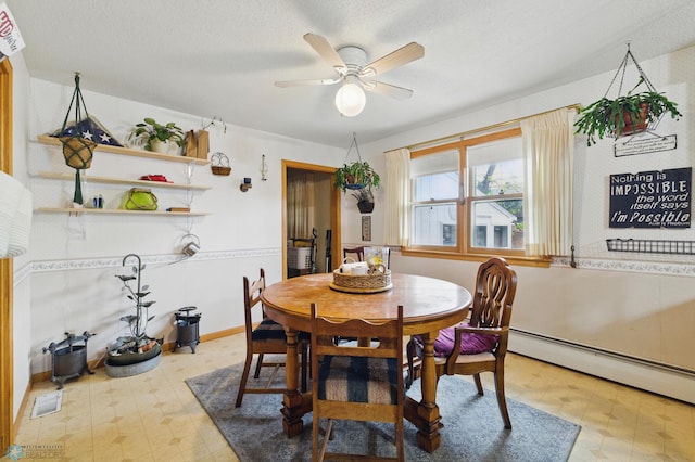 1013 15 1/2 St N, Moorhead, MN 56560 - dining space featuring light floors, ceiling fan, a baseboard heating unit, and a textured ceiling