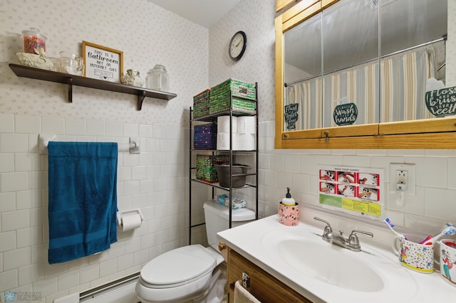 1013 15 1/2 St N, Moorhead, MN 56560 - full bathroom featuring tile walls, wallpapered walls, toilet, vanity, and a baseboard heating unit