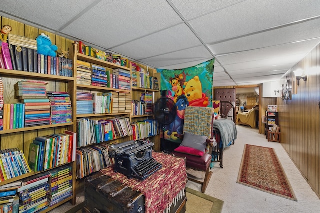 1013 15 1/2 St N, Moorhead, MN 56560 - living area featuring carpet floors, a drop ceiling, and wood walls