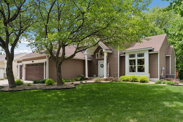 6609 Red Birch Ct, Lino Lakes, MN 55014 - view of front facade featuring an attached garage, a front yard, a shingled roof, and central AC unit